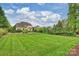 Expansive backyard featuring large lawn, pool, and privacy trees at 20635 Queensdale Dr, Cornelius, NC 28031