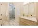 A bathroom featuring a shower and a single sink vanity with a framed mirror at 20635 Queensdale Dr, Cornelius, NC 28031