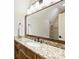 Bathroom features a granite countertop, wood cabinets, a large mirror, and a tiled shower at 20635 Queensdale Dr, Cornelius, NC 28031
