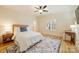 Bedroom with a ceiling fan, wood floors, a woven bed, and a colorful area rug at 20635 Queensdale Dr, Cornelius, NC 28031