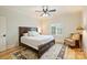 Cozy bedroom features a wood-framed bed, ceiling fan, plantation shutters, and elegant area rug at 20635 Queensdale Dr, Cornelius, NC 28031