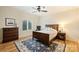 Bedroom with wood floors, a dark-stained wood bed, and an area rug at 20635 Queensdale Dr, Cornelius, NC 28031