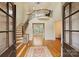 A grand foyer with a staircase, hardwood floors, and elegant details that welcomes you into the home at 20635 Queensdale Dr, Cornelius, NC 28031