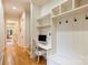 Hallway featuring hardwood floors, desk, and storage, creating a bright and functional space for work or organization at 20635 Queensdale Dr, Cornelius, NC 28031