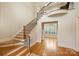 An elegant foyer featuring a wooden staircase with iron railings and abundant natural light from a bay window at 20635 Queensdale Dr, Cornelius, NC 28031