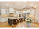 A gourmet kitchen featuring a large island, modern appliances, custom cabinets, and stylish pendant lighting at 20635 Queensdale Dr, Cornelius, NC 28031
