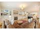 Bright, open living area featuring a fireplace, hardwood floors, comfortable seating, and a view into the kitchen area at 20635 Queensdale Dr, Cornelius, NC 28031