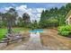 Inviting backyard pool area with mature trees, lounge chairs, and a spa for outdoor enjoyment at 20635 Queensdale Dr, Cornelius, NC 28031
