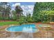 Backyard pool and spa surrounded by a patio and lush greenery offering a private retreat at 20635 Queensdale Dr, Cornelius, NC 28031