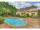Beautiful in-ground pool with adjacent stone hot tub and steps by home at 20635 Queensdale Dr, Cornelius, NC 28031