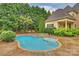 Beautiful in-ground pool with adjacent stone hot tub and steps at 20635 Queensdale Dr, Cornelius, NC 28031