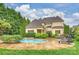 Beautiful in-ground pool with adjacent stone hot tub, steps, and chairs at 20635 Queensdale Dr, Cornelius, NC 28031