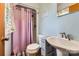 Bright bathroom featuring a shower-tub combo and pedestal sink at 209 Vanderbilt Ave, China Grove, NC 28023