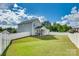 Expansive fenced backyard featuring lush green lawn, a covered patio, and privacy at 2222 Smoltz Dr, Rock Hill, SC 29730