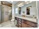 Bathroom featuring double sinks, granite countertops, wood cabinets and a glass-enclosed shower at 2222 Smoltz Dr, Rock Hill, SC 29730