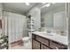 Well-lit bathroom with a white sink, dark wood vanity, and decorative shelves at 2222 Smoltz Dr, Rock Hill, SC 29730