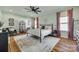 Bright bedroom featuring a ceiling fan, wood floors, decorative pillows, and a wrought iron bed frame at 2222 Smoltz Dr, Rock Hill, SC 29730