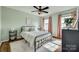 Bedroom with a black metal bed frame, windows, and salmon-colored curtains at 2222 Smoltz Dr, Rock Hill, SC 29730
