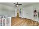 Bedroom with wood floors, ceiling fan, ample closet space, and a cozy crib at 2222 Smoltz Dr, Rock Hill, SC 29730