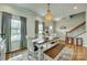 Bright dining room with wood floors, an elegant chandelier, and a farmhouse-style table and seating at 2222 Smoltz Dr, Rock Hill, SC 29730