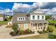 Beautiful two-story home with stone accents, a covered porch, and professionally landscaped yard at 2222 Smoltz Dr, Rock Hill, SC 29730