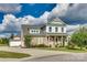 Charming two-story home with stone accents, a covered porch, and well-manicured landscaping at 2222 Smoltz Dr, Rock Hill, SC 29730