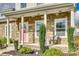 Inviting front porch featuring stone accents, quaint seating, and a welcoming coral-colored front door at 2222 Smoltz Dr, Rock Hill, SC 29730