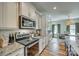 Stylish kitchen with white cabinets, granite countertops, stainless steel appliances, and an adjoining dining space at 2222 Smoltz Dr, Rock Hill, SC 29730