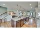 Large kitchen island with granite countertops, dark wood cabinets, and an open view into the living room at 2222 Smoltz Dr, Rock Hill, SC 29730