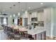 Spacious kitchen island with granite countertops, pendant lighting, barstool seating, and stainless steel appliances at 2222 Smoltz Dr, Rock Hill, SC 29730