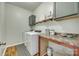 A well-lit laundry room with wood-look flooring, a folding counter, and modern appliances at 2222 Smoltz Dr, Rock Hill, SC 29730