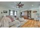 Cozy living room featuring a large ceiling fan, comfortable seating, and a stylish wooden bookcase with sliding door at 2222 Smoltz Dr, Rock Hill, SC 29730