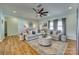 Bright living room with hardwood floors, a ceiling fan, and a large sectional sofa with decorative pillows at 2222 Smoltz Dr, Rock Hill, SC 29730