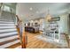 Open concept kitchen, dining, and staircase featuring wood floors, a large island, and modern lighting at 2222 Smoltz Dr, Rock Hill, SC 29730