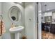 The powder room has a pedestal sink, decorative mirror, and hardwood floors at 2222 Smoltz Dr, Rock Hill, SC 29730