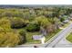 Overhead shot of house surrounded by mature trees, foliage, and a paved road at 2300 Linwood Rd, Gastonia, NC 28052