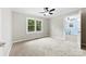 Bedroom featuring neutral walls, a ceiling fan, and a window with a view of greenery at 2300 Linwood Rd, Gastonia, NC 28052