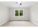 Bedroom with neutral walls, a ceiling fan, and a large window offering natural light at 2300 Linwood Rd, Gastonia, NC 28052