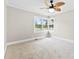 Carpeted bedroom featuring crown molding, a ceiling fan, and a corner window offering natural light at 2300 Linwood Rd, Gastonia, NC 28052