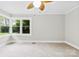 Bedroom with neutral walls, a large window with a view of greenery, and neutral carpet at 2300 Linwood Rd, Gastonia, NC 28052
