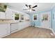 Bright kitchen with a door to the back, featuring white cabinets, sleek appliances, and wood-look flooring at 2300 Linwood Rd, Gastonia, NC 28052