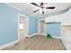 Charming kitchen with blue walls, white cabinets, wood-look flooring, and convenient access to adjacent rooms at 2300 Linwood Rd, Gastonia, NC 28052