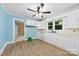 Bright kitchen with blue walls, white cabinets, modern appliances, and views to the living room, offering both style and functionality at 2300 Linwood Rd, Gastonia, NC 28052