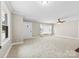 Inviting living room with neutral walls, plush carpeting, and multiple windows, creating a bright and welcoming atmosphere at 2300 Linwood Rd, Gastonia, NC 28052