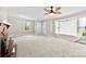 Cozy living room with a brick fireplace, neutral walls, large windows, and carpeted floors, creating a comfortable atmosphere at 2300 Linwood Rd, Gastonia, NC 28052