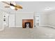 Spacious living room with neutral walls, a brick fireplace, modern ceiling fan, and views into adjoining rooms at 2300 Linwood Rd, Gastonia, NC 28052