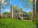 A spacious backyard features a screened-in porch, deck, grill area, and lush green lawn, perfect for outdoor gatherings at 2812 Edgebrook Cir, Matthews, NC 28105