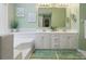 Well-lit bathroom with a double sink vanity, a large mirror, and fresh green accents at 2812 Edgebrook Cir, Matthews, NC 28105