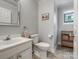 Charming half-bathroom with a vanity, toilet, and a stained-glass window accent at 2812 Edgebrook Cir, Matthews, NC 28105