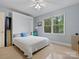 Light and open bedroom with a built-in murphy bed with large windows and ceiling fan at 2812 Edgebrook Cir, Matthews, NC 28105